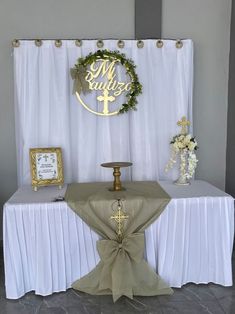 a white table topped with a cake and a cross