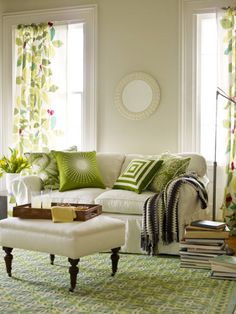 a living room with green and white decor