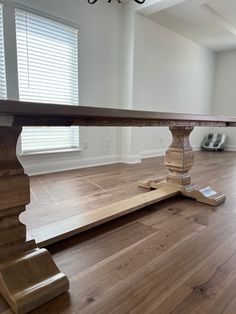 a wooden table sitting on top of a hard wood floor