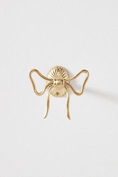 a gold plated spider brooch on a white background