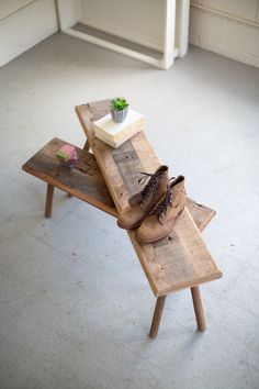 a pair of shoes sitting on top of a wooden table