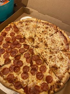 a large pepperoni pizza sitting in a box