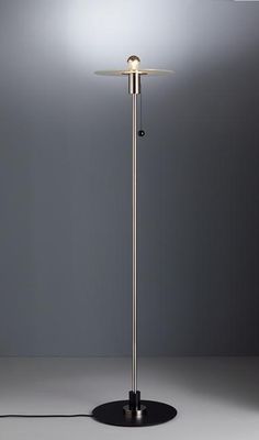 a floor lamp with a dim light on it's side and a black base