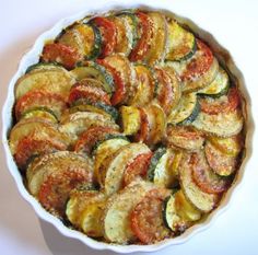 a white dish filled with sliced up vegetables