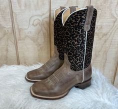 Everyone needs a pair of cheetah print cowboy boots in their closet! This Roper has a cheetah printed on faux brushed shaft and waxy brown full grain leather foot. Made for comfort, it has a REST comfort insole and dynamic arch support. 8 inch shaft height Leather lining  Double stitch welt Leather outsole  1 1/4 inch Western Brown Calf Hair Boots, Fitted Leopard Print Boots With Round Toe, Cheetah Print Boots Outfit, Print Boots Outfit, Square Toe Cowgirl Boots, Tan Square, Cowgirl Boots Square Toed, Cute Cowgirl Boots, Square Toe Western Boots