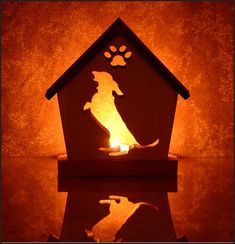 a dog house with a lit candle in the shape of a dog's paw