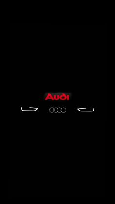 an audi logo is shown in the dark with red lettering on it's side