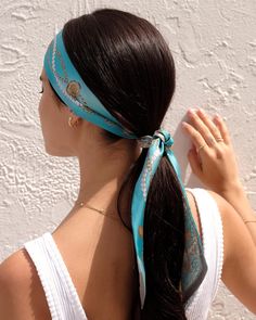 a woman with long hair wearing a blue bandana