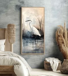 a white bird is standing in the water near a bed with pillows and blankets on it