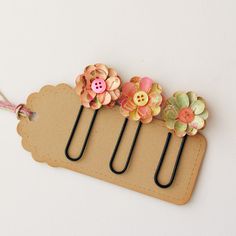 a pair of hair clips with flowers on them