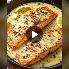 two salmon fillets with lemon sauce in a skillet