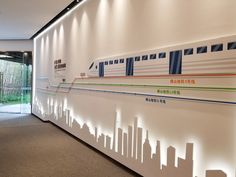 an office lobby with white walls and city silhouettes on the wall