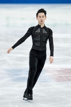 a male figure skating on an ice rink