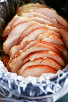 slices of ham in foil wrapped in plastic