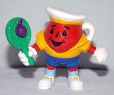 a toy figure holding a tennis racket and ball