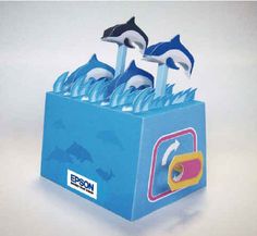 an orca whale and two dolphins in a blue box