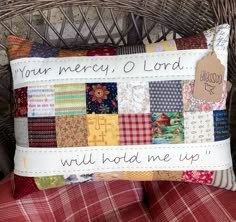 a pillow that has been made to look like a patchwork quilt with words on it