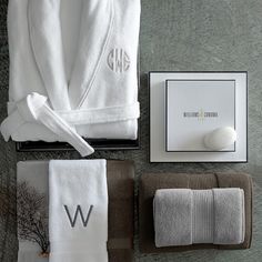 towels and personal items are laid out on the floor, including a bathrobe