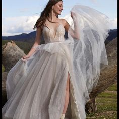 a woman in a white dress with a long veil on her head and one leg