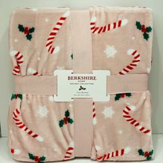 two pink christmas blankets with candy canes on them