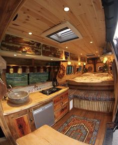 an inside view of a camper with wood paneling