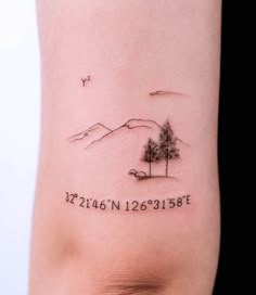 a small tree on the side of a woman's arm with her date tattooed