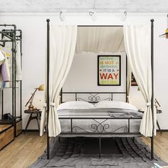 a bedroom with a four poster bed and lots of clothes hanging on the wall next to it