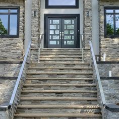 a stone building with stairs leading up to the front door