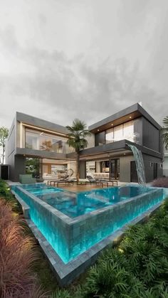 a large pool in front of a modern house with a waterfall coming out of it