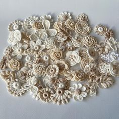 crocheted flowers are arranged on a white surface