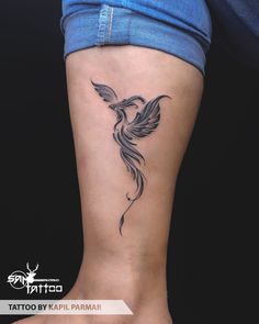 a woman's leg with a tattoo on it that has a bird in flight