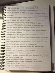 an open notebook with the words language techniques written in green and blue ink on it