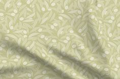 a green and white wallpaper with an apple tree pattern on the bottom half of it