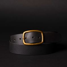 Handmade in our Toronto studio, Amara is a full grain leather belt that features a gold, rounded buckle. It can be worn as a waist belt around a dress or a regular belt around some high rise jeans. The meaning behind Amara, "Eternal," perfectly captures the essence of this versatile belt that you'll adore and cherish for a lifetime. One solid piece of full grain leather. No bonded belts, period. This results in a belt that minimizes stretch and will never break or crack at the holes. Crafted to Black Brass Buckle Belt For Workwear, Gold Belt Buckles For Work, Gold Belt With Brass Buckle For Work, Elegant Black Belt With Brass Buckle, Chic Adjustable Belt With Brass Buckle, Chic Black Belt Buckles With Brass Detail, Chic Black Belt Buckles With Brass Buckle, Chic Black Belt With Brass Buckle, Belt With Gold Buckle