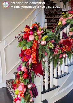 an arrangement of flowers and greenery on the banister