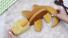 a person holding a piece of bread on top of a counter