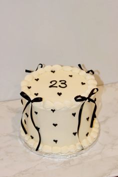 a decorated cake with the number twenty eight on it sitting on a marble countertop