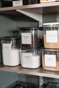 several containers with labels on them are stacked on shelves in a pantry, one is filled with chocolate chips and the other has cookies