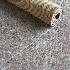 a roll of carpet sitting on top of a floor