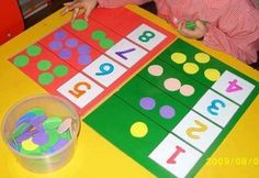 a child is sitting at a table playing with numbers