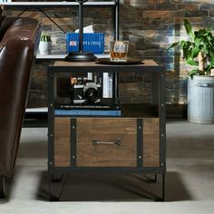 a brown couch sitting next to a table with a book shelf on top of it