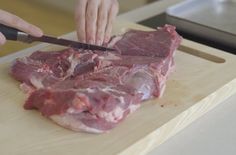 a person cutting up meat with a knife