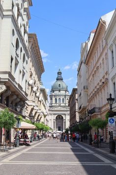 an empty city street lined with tall buildings