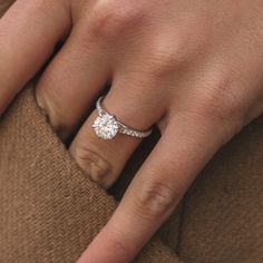 a woman's hand with a diamond ring on it