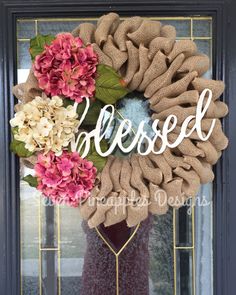 a wreath with the word messed written on it and some flowers in front of it