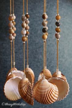 seashells hanging from strings with beads and pearls