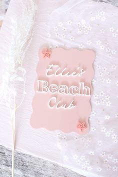 a pink cake with white frosting that says,'this beach club'on it