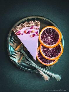 a plate topped with slices of grapefruit, oranges and a slice of cake