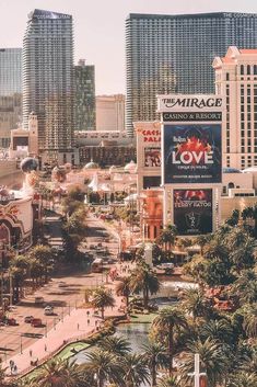 the las vegas strip is crowded with people and buildings in the background, as well as palm trees