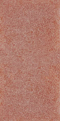 an orange square tile with white speckles